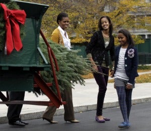 Michelle Obama and Daughters Welcome Christmas Tree