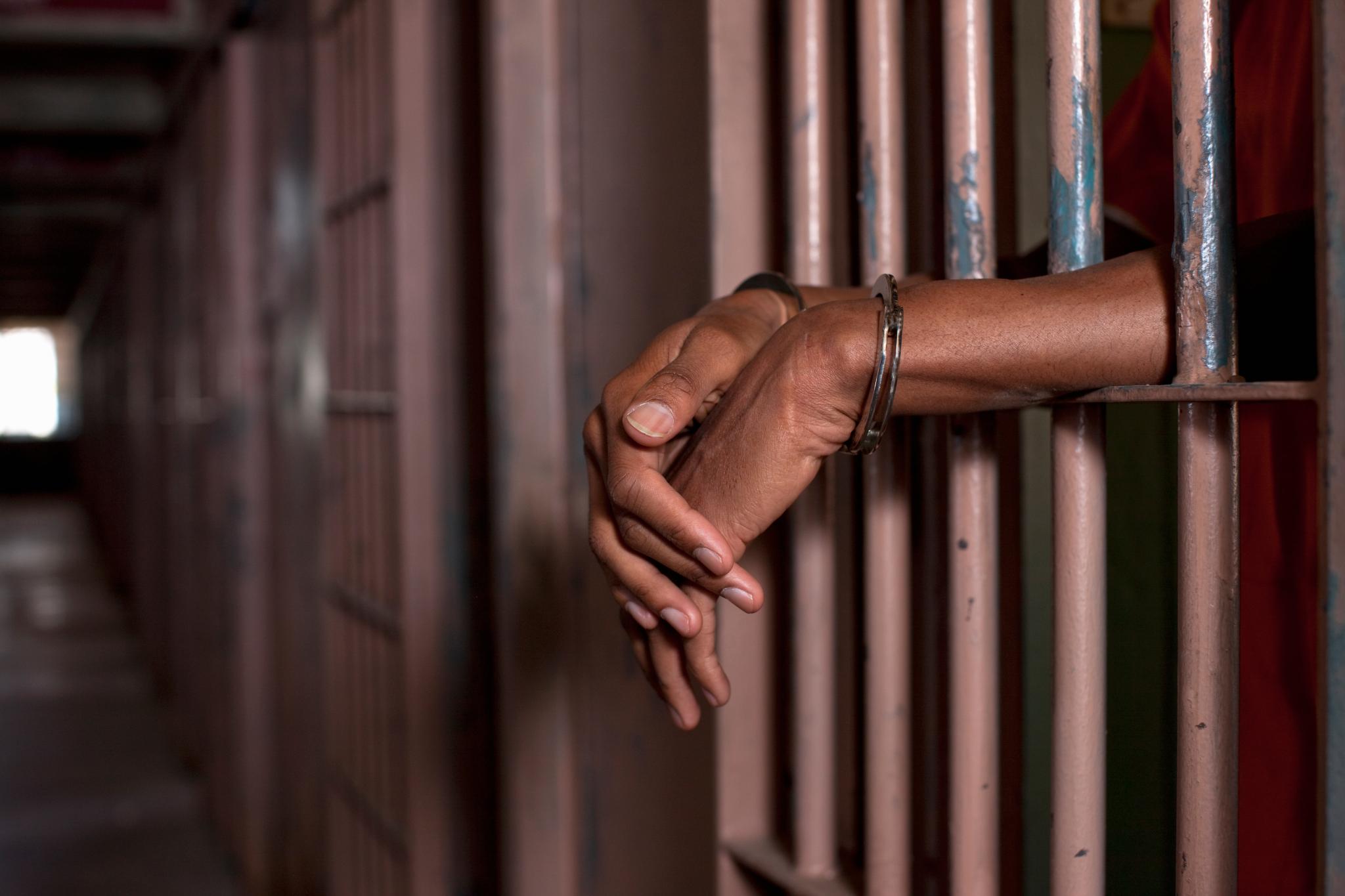 Image result for Images of a black prisoner in prison handcuffed