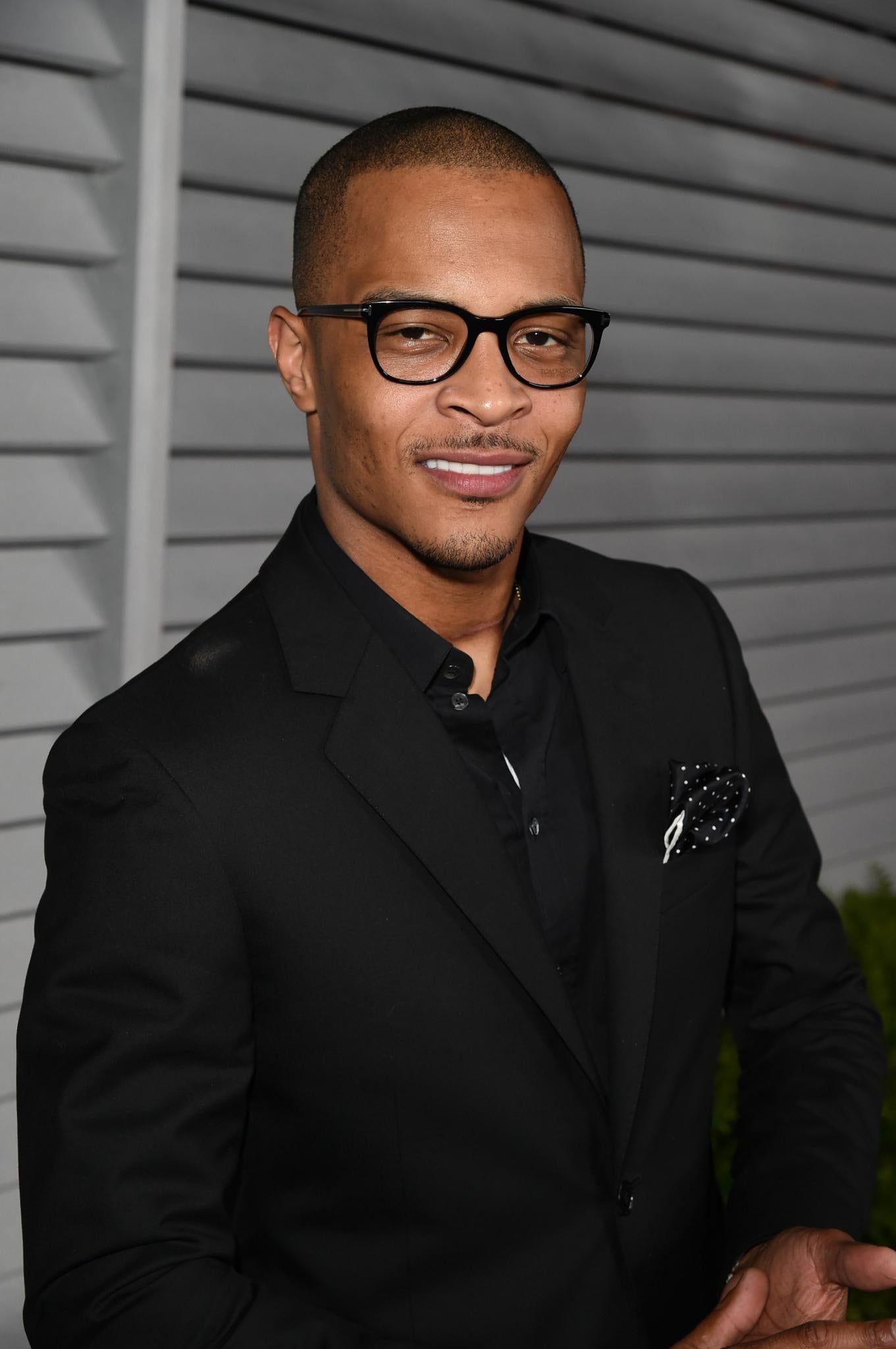 Very Married T.I.'s Reaction to a Sneaky Fan Trying To Kiss Him Is Everything
