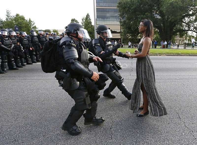 Photo Of Black Woman Peacefully Protesting Against Officers In Riot Gear Goes Viral
