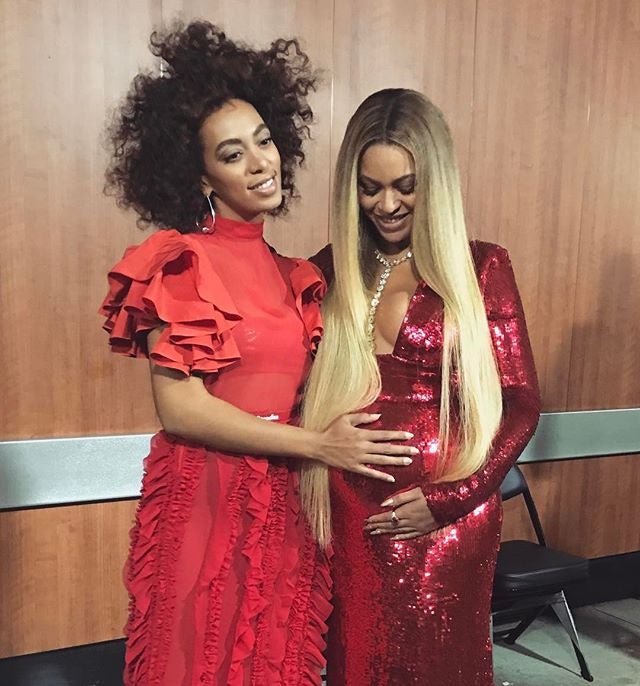 Solange Rubs On Big Sis Beyoncé’s Baby Bump Backstage At The Grammys In A Tender Moment