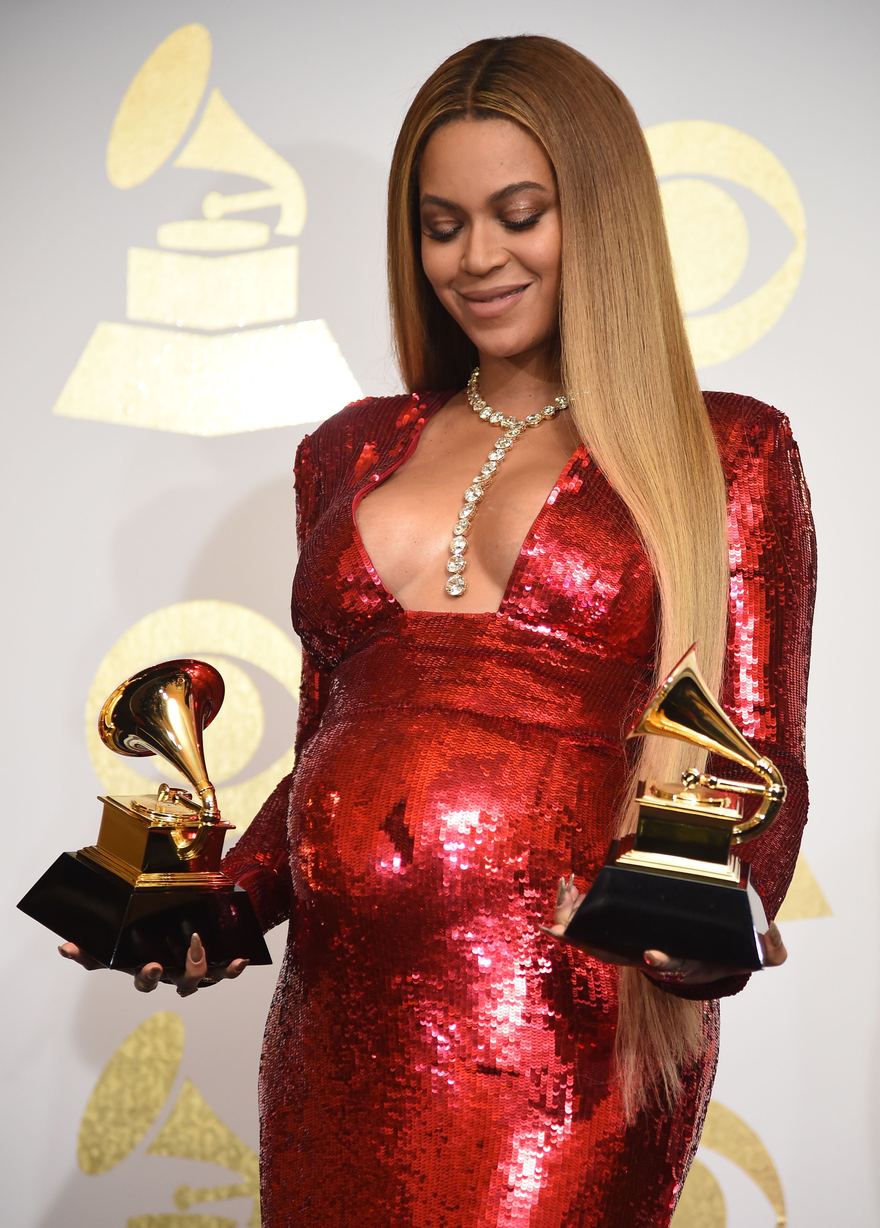 Solange Rubs On Big Sis Beyoncé’s Baby Bump Backstage At The Grammys In A Tender Moment