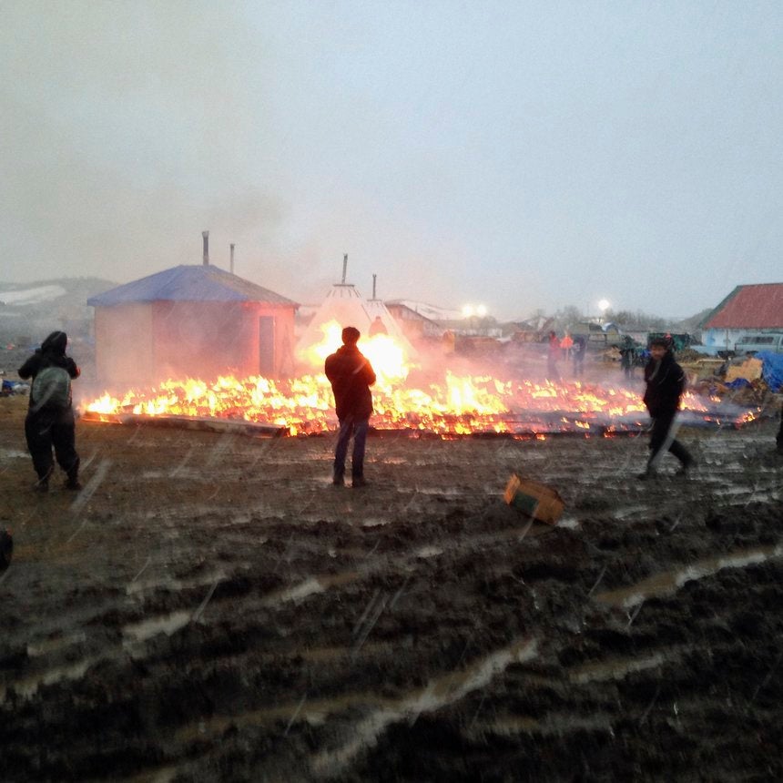 Protesters Pray And Set Fire At Dakota Access Pipeline Camp Ahead Of Shutdown
