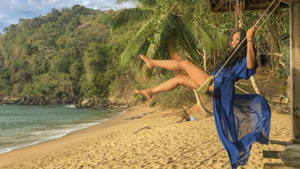 Black Travel Moment Of The Day: This Woman Happily Swinging On The Beach in Tobago Will Make Your Monday