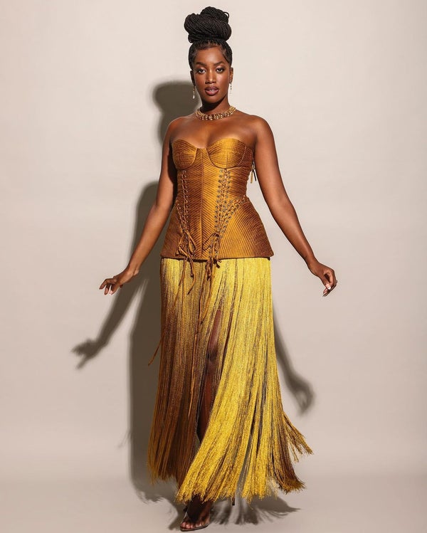 Woman in gold sleeveless dress