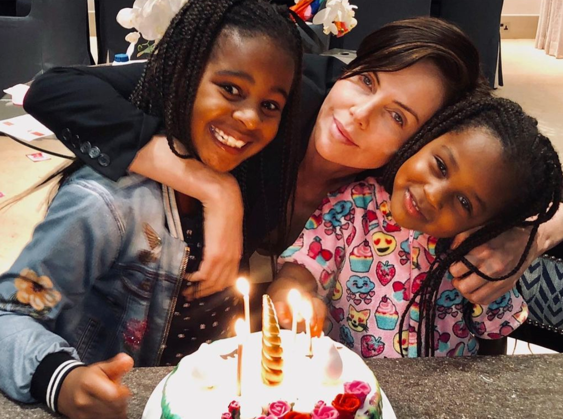 https://www.essence.com/wp-content/uploads/2021/10/Charlize-Daughters.png?width=1280